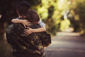 Little boy and soldier in a military uniform