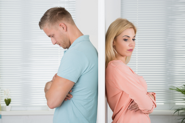 A couple with a wall between them after a fight